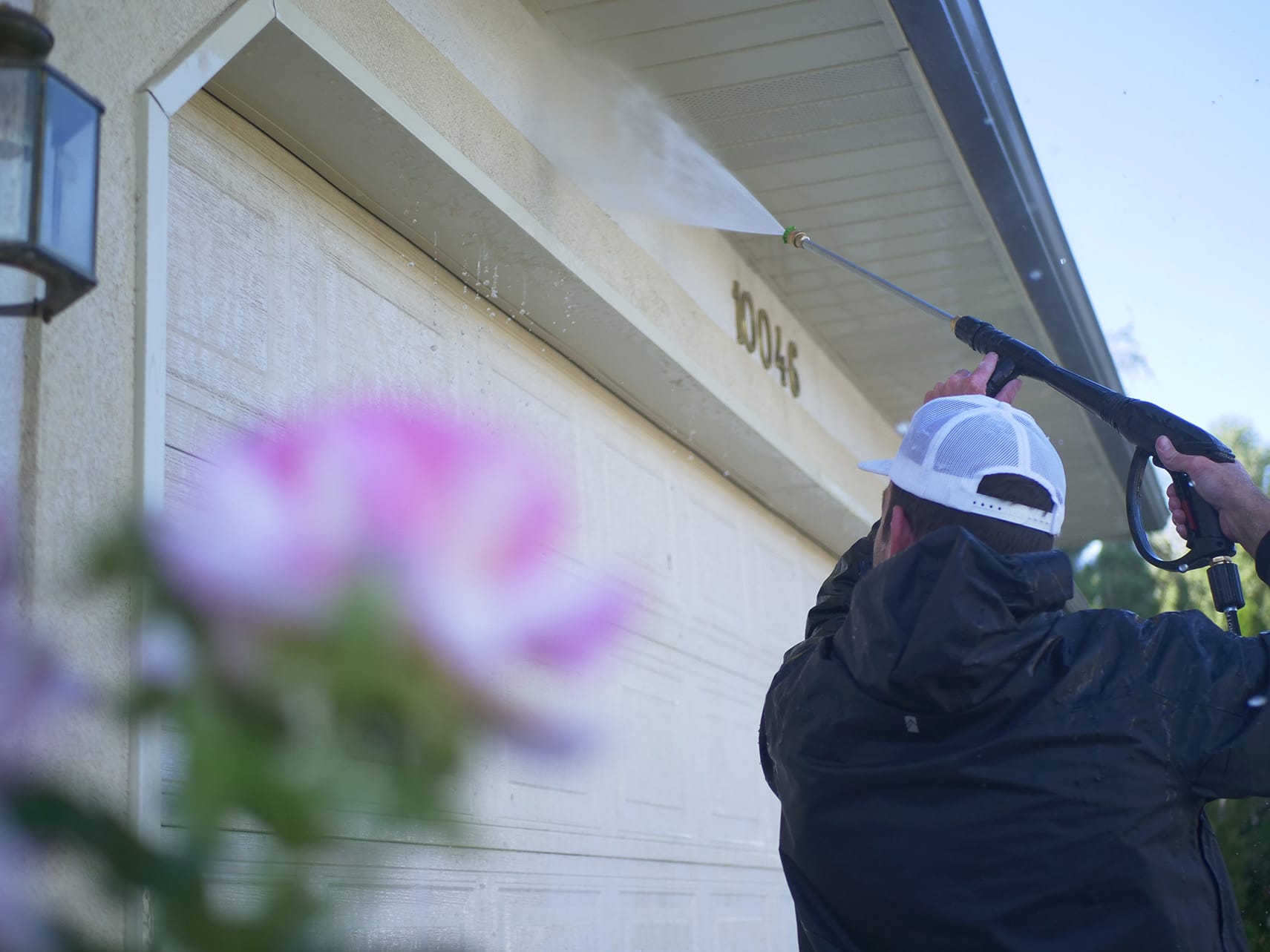 a guy cleaning outside a house