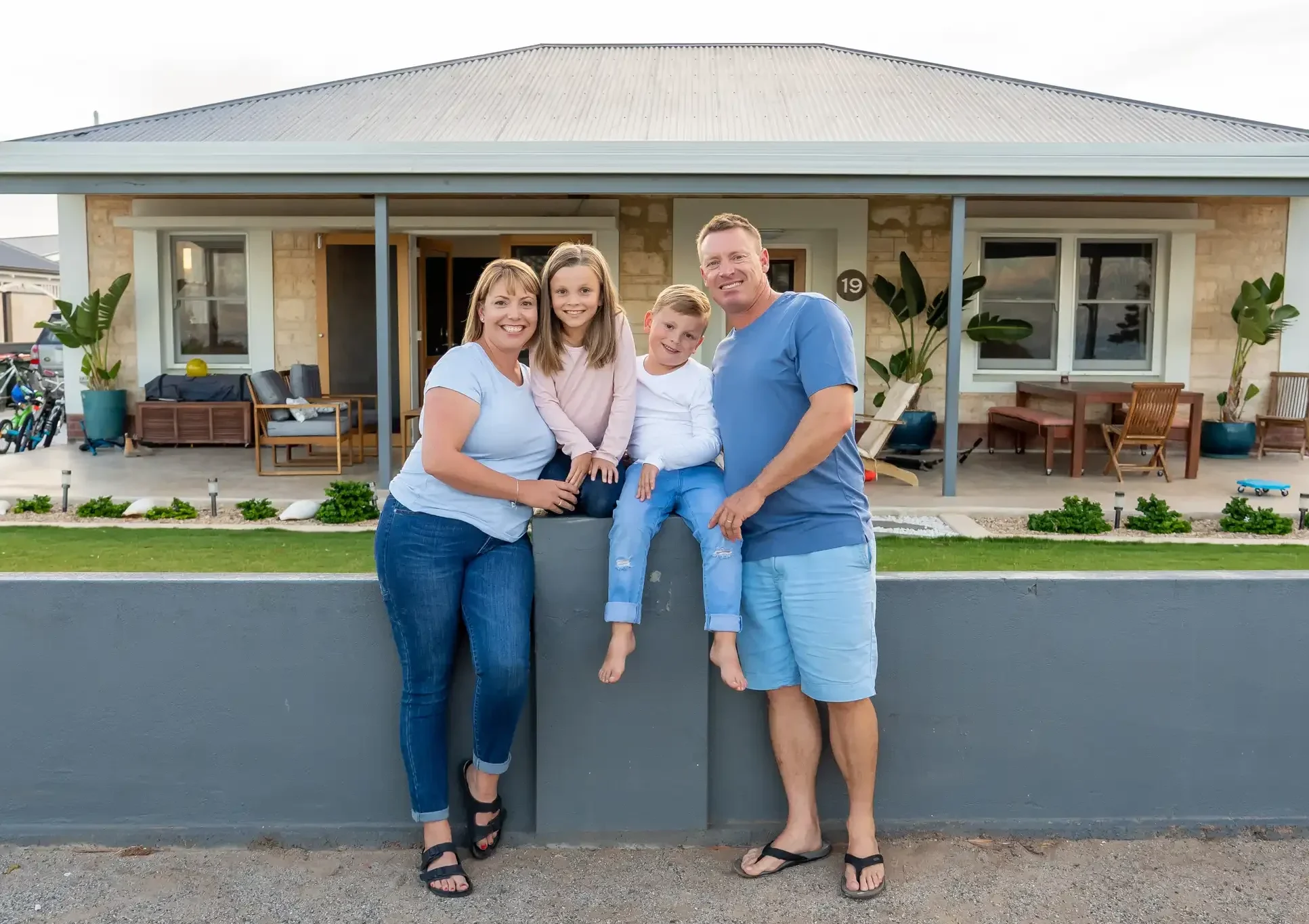 family in front of new home